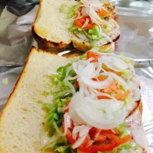 three sandwiches on tin foil