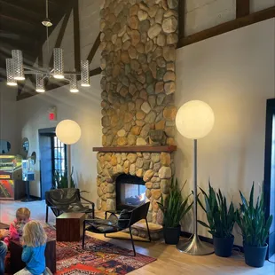 a living room with a stone fireplace