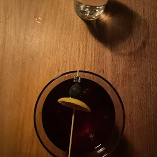 a glass of water and a cocktail on a table