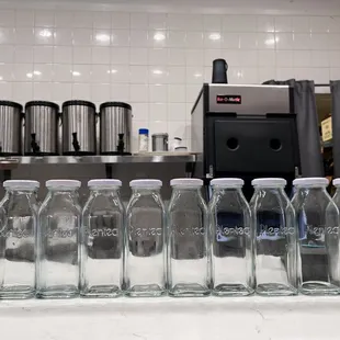 a row of empty bottles on a counter