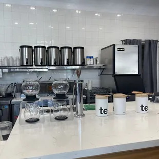 a kitchen with a counter and pots and pans