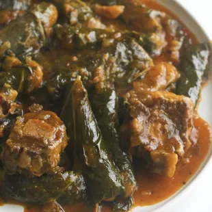 a plate of meat and greens