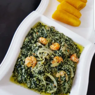 a plate of shrimp and spinach
