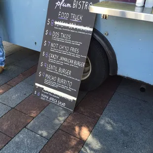 a menu on the side of a food truck