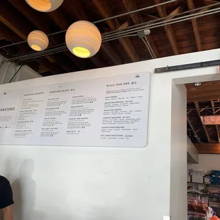 a man standing in front of a menu