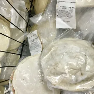 a variety of cheeses wrapped in plastic
