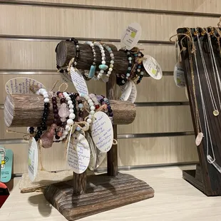 a display of jewelry on a wooden stand