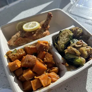 Combo plate with chicken, sweet potatoes, and Brussels sprouts