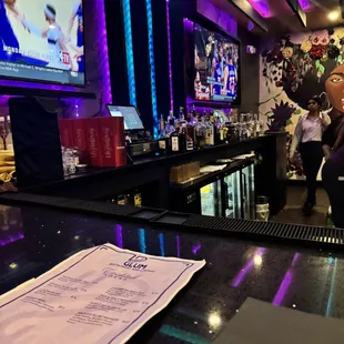 a bar with a television and a menu