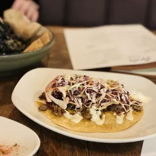 Brisket Taco with Serrano crema and white cheddar.