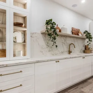 Beautiful, open kitchen layout with a variety of easily accessible storage and organization features including an appliance lift, spice rack