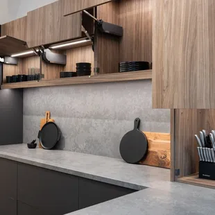 Custom cabinetry featuring anti-fingerprint finish, mechanical lift hardware, recessed lighting and garage appliance. Localy made in Hawaii.