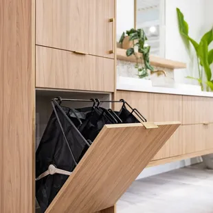 Hideaway laundry hampers and bathroom vanity in light walnut finish. Locally made in Hawaii.