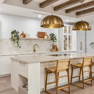 White cabinetry with large island and glass shaker doors. Locally made in Hawaii.