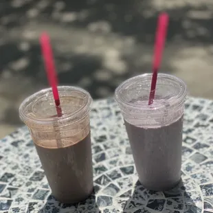 two smoothie drinks on a table