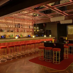 a bar with red bar stools