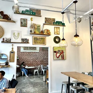 An adjacent room with communal table and counter seating.