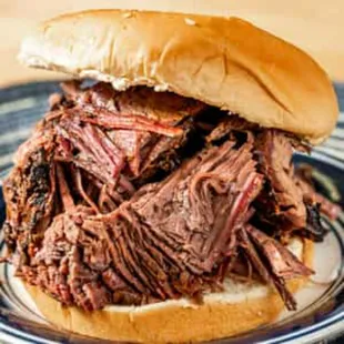 Brisket sandwich,  with sauce on the side.