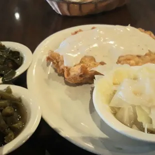 Fried chicken breast with white gravy. Collard greens, green beans,  and cabbage. And a pina colada.