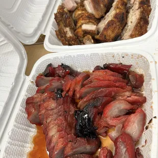 a variety of meats in styrofoam containers