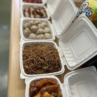 a variety of chinese food in containers