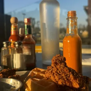 Chicken and Waffles, house salsa , and Spring water in glass.