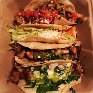 4 tacos (spicy tinga, carne asada, epasote mushroom, and carnitas). Yum!