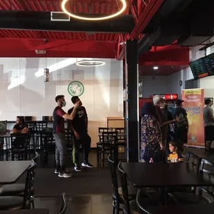 Only 2 men wearing a mask. There were 10 men sitting at 1 table on the left.