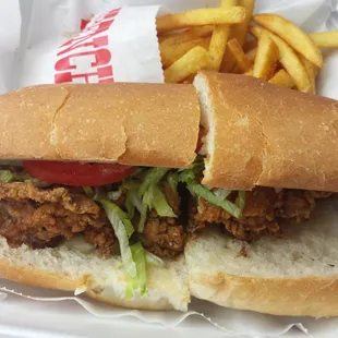 Seasoned fries behind oyster poboy.