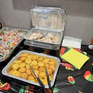 Catered food for a Black History Month Luncheon: salad, mini cornbread muffins, beignets