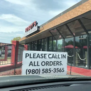 a sign in front of a restaurant