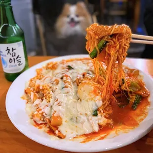 Cheesy Rabokki: Spicy Rice Cakes + Ramen w/ fishcakes, green onions, egg | $21