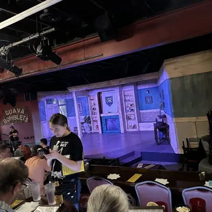 a group of people seated in front of a stage