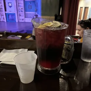 a pitcher of lemonade and a glass of water