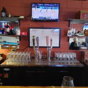 a bar with wine glasses on the bar