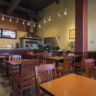 the inside of a restaurant with tables and chairs