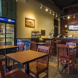 the inside of a restaurant with tables and chairs