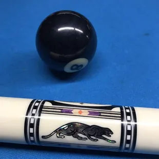 a pool cue and a pool ball