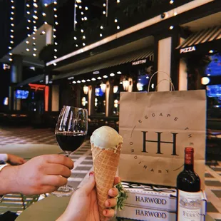 a person holding an ice cream cone