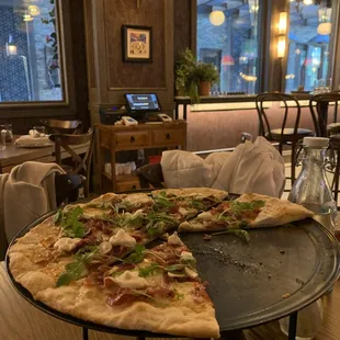 a pizza on a table in a restaurant