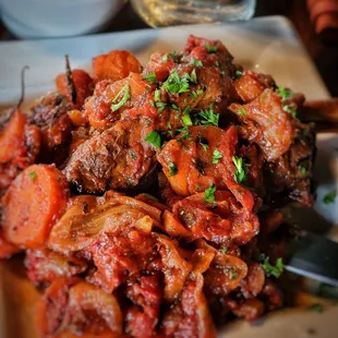 Exquisite Lamb Shank Osso Bucco, detail with carrots, tomatoes, spices... PERFECTION.