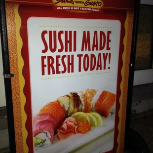 a sushi made fresh today sign