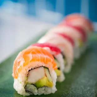 a sushi roll on a green plate