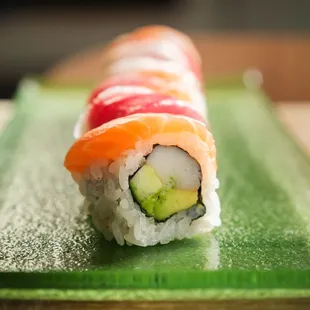 a sushi roll on a green plate