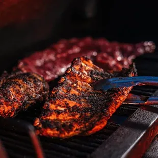 ows a closeup of a bbq on a grill