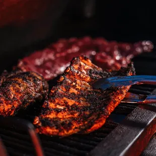 ows the meat being cooked on the grill