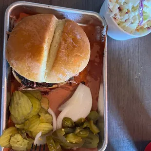 Sliced brisket sandwich and a side of coleslaw.