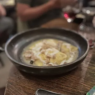 a bowl of pasta and a spoon on a table