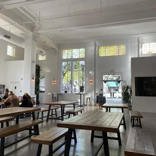 a large room with tables and benches