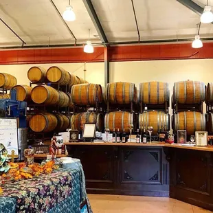 a wine tasting area with barrels